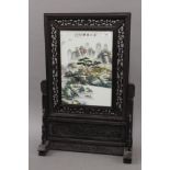 A Chinese porcelain screen on wooden stand. 67.5 cm high.