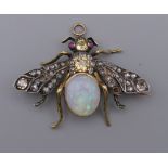 An unmarked gold diamond, opal and ruby brooch formed as a fly. 4.5 cm wide. 10.