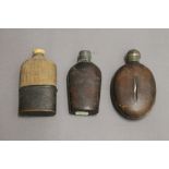 Three hip/spirit flasks. The largest 14 cm high.