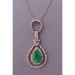 An 18 ct gold Art Deco style heart shape emerald and diamond pendant on an 18 ct white gold chain.