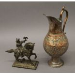 A copper ewer with Middle Eastern design and a figure on horseback. The former 32 cm high.