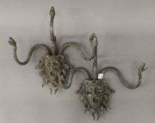 A pair of bronze wall sconces formed as Medusa. Each 34 cm wide.