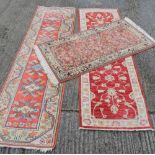 Two modern red ground wool runners and a rug. 270 x 81 cm, 290 x 81 cm, 178 x 91 cm.