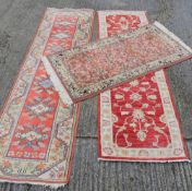 Two modern red ground wool runners and a rug. 270 x 81 cm, 290 x 81 cm, 178 x 91 cm.