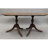 A modern mahogany twin pedestal dining table, with single leaf. 212 cm long.