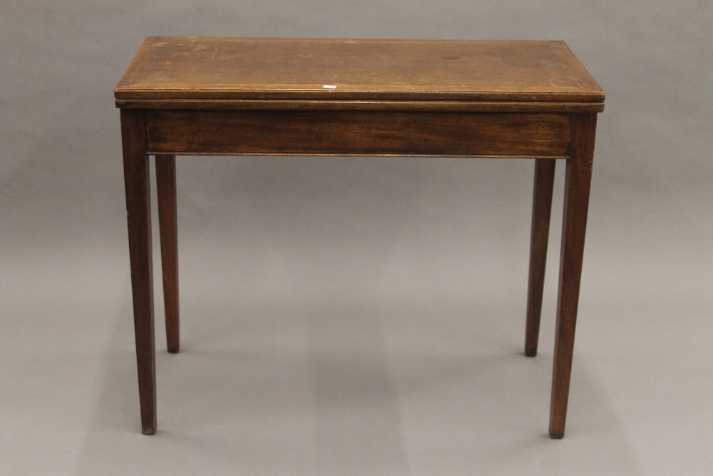 A 19th century mahogany fold over tea table. 91 cm wide.