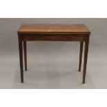 A 19th century mahogany fold over tea table. 91 cm wide.