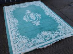 A large turquoise ground rug. 413 x 306 cm.