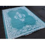 A large turquoise ground rug. 413 x 306 cm.