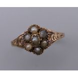 An Antique 12 ct gold seed pearl ring. Ring Size R/S. 1.6 grammes total weight.