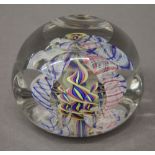 A faceted glass paperweight. 5 cm high.