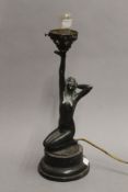 An Art Deco lamp formed as a nude lady. 32 cm high.