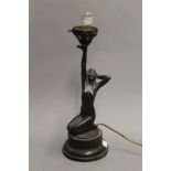 An Art Deco lamp formed as a nude lady. 32 cm high.