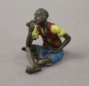 A cold painted bronze model of an Arab boy. 6 cm high.