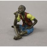 A cold painted bronze model of an Arab boy. 6 cm high.