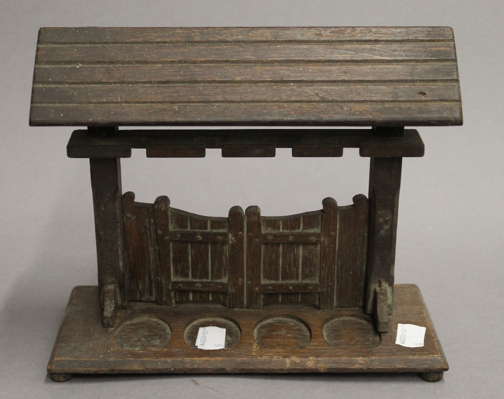 A wooden pipe rack formed as a gateway. 23 cm wide.