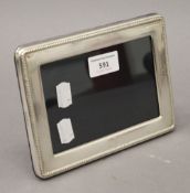 A silver photograph frame, hallmarked Birmingham 2005. 18 cm wide.