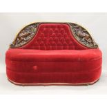 A Victorian carved walnut red velvet upholstered settee. 156 cm wide.