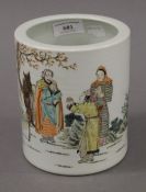 A Chinese porcelain brush pot decorated with figures. 15 cm high.