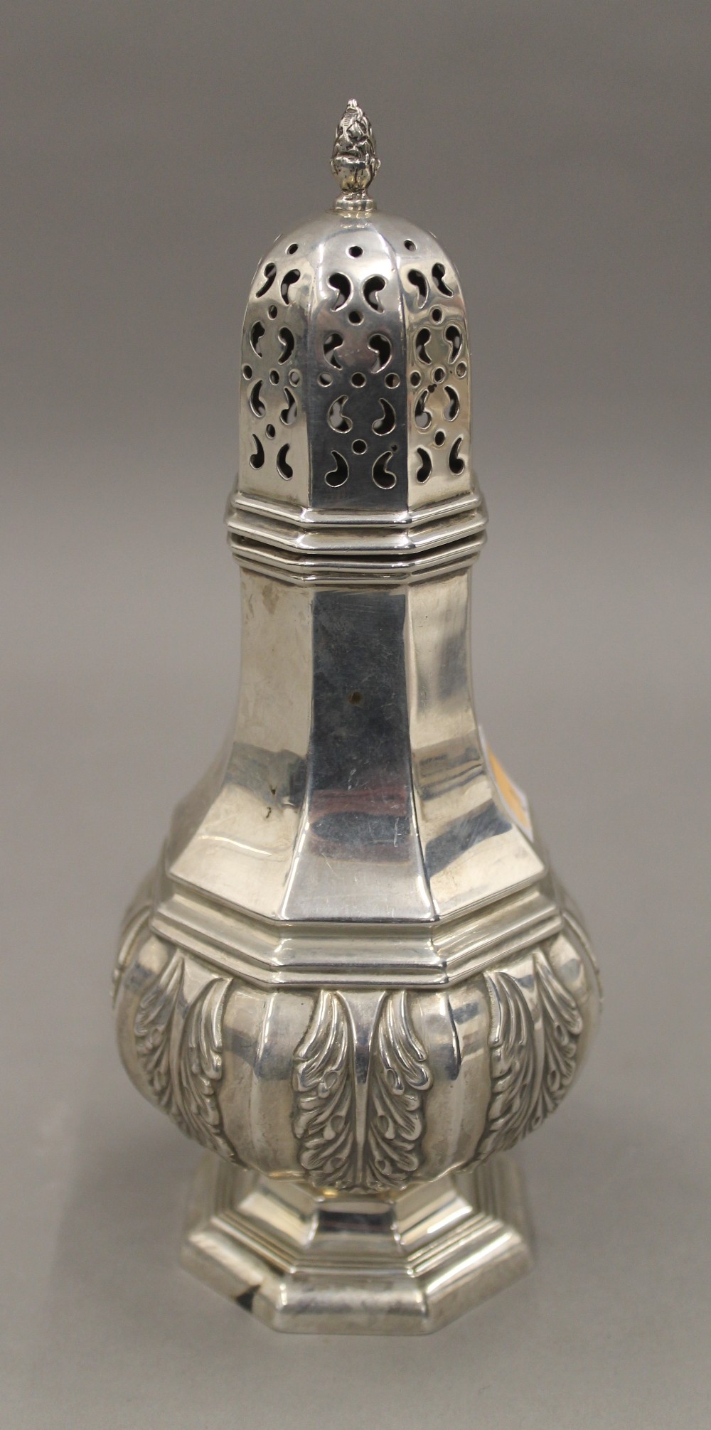 A silver sugar caster with cast acanthus decoration. 19 cm high. 6.7 troy ounces.