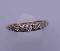A 15 ct gold five stone diamond ring. Ring size O/P. 2 grammes total weight.