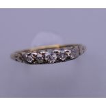 A 15 ct gold five stone diamond ring. Ring size O/P. 2 grammes total weight.