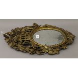 A 19th century carved gilt wood wall glass. 55 cm high.