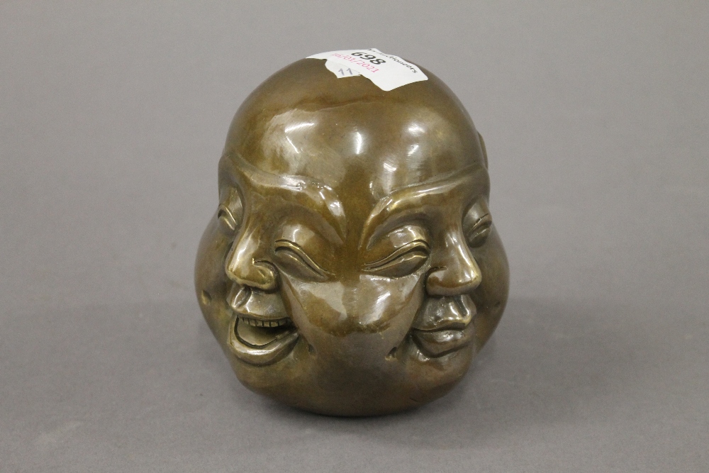 A bronze four faced buddha head. 11 cm high.