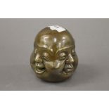 A bronze four faced buddha head. 11 cm high.