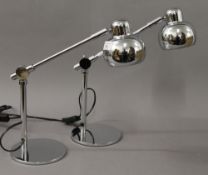 A pair of chrome anglepoise lamps