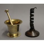 An 18th century brass bell shaped pestle and mortar,