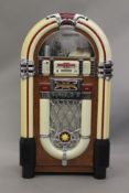 A compact disc formed as a baby juke box. 100 cm high.