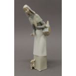 A Lladro figurine, a lady holding a bread basket. 27 cm high.