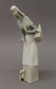 A Lladro figurine, a lady holding a bread basket. 27 cm high.