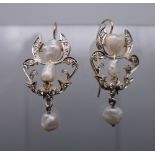 A pair of unmarked gold and pearl earrings. 3 cm high.