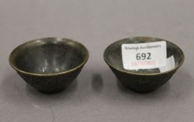 A pair of small Chinese bronze bowls. 6 cm diameter.