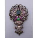 A vintage silver and gold mounted emerald, diamond and ruby pendant. 7.5 cm high. 21.