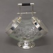 A silver plated and glass double biscuit box. 28 cm high.