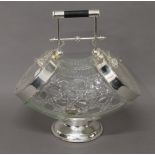 A silver plated and glass double biscuit box. 28 cm high.
