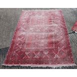 A red ground rug. 236 x 159 cm.