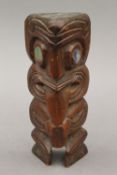 A Maori carved wooden Tiki figure. 18 cm high.