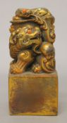 A gilt bronze, coral and turquoise dog-of-fo seal. 12 cm high.