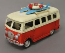 A tin model of a Volkswagen camper van. 23 cm long.