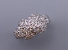 A silver cubic zirconia crossover ring. Ring size O/P.