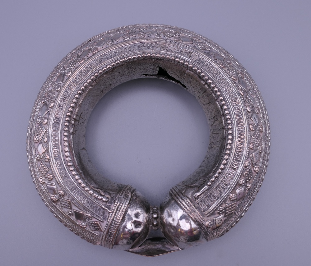 Three Eastern white metal bangles, two probably unmarked silver. The largest 12.5 cm diameter. - Image 8 of 14