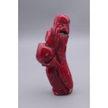 A carved coral figure. 9.5 cm high.