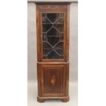 An Edwardian inlaid mahogany corner cabinet. 201 cm high.