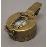 A brass compass. 6 cm wide.