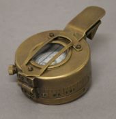 A brass compass. 6 cm wide.