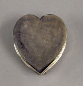 A silver heart shaped trinket box. 8.5 cm wide. 2.7 troy ounces total weight.